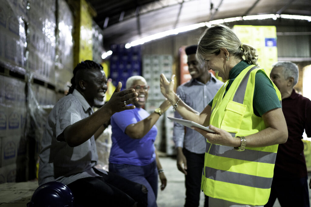 Happy employees celebrating together at warehouse